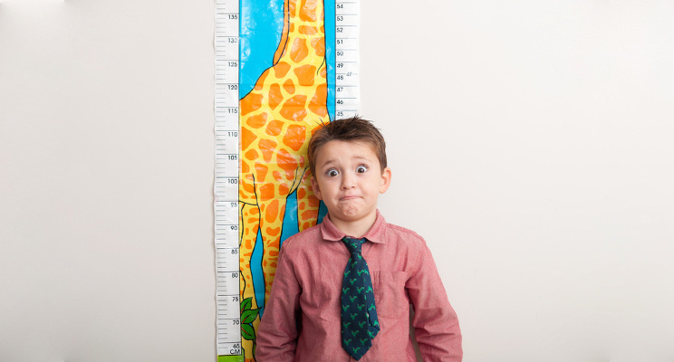 boy measuring his height